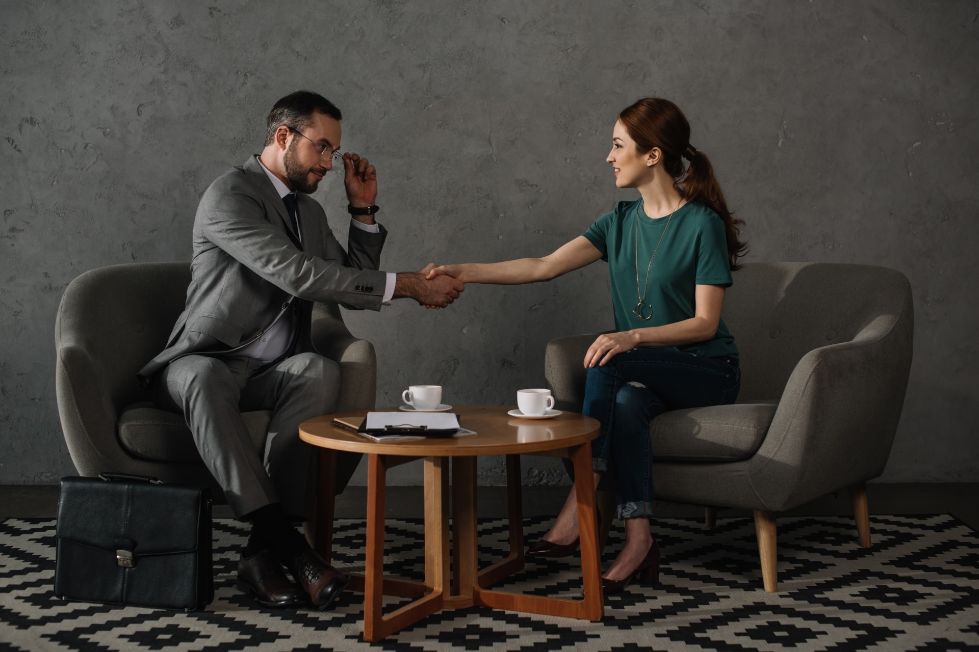 Attorney and client meet at small coffee table