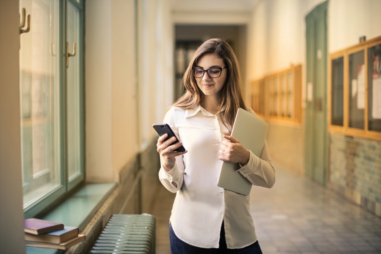 Mobile-first indexing enabled on website as young multiethnic couple uses mobile device and laptop computer