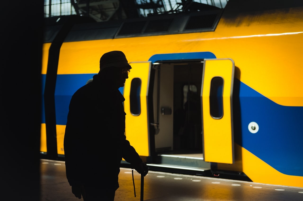 Nonprofit storytelling uses a silhouette of elderly man waiting to board subway train.